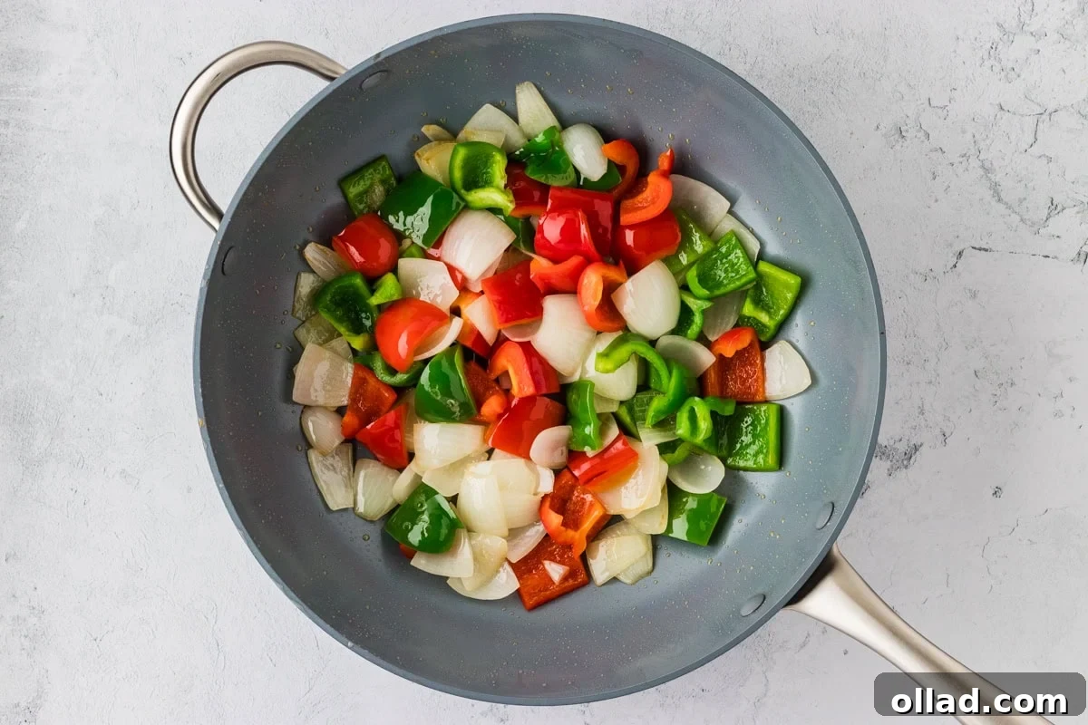 Irresistible Gluten-Free Sweet and Sour Chicken 16 sautéed bell peppers and onion in wok