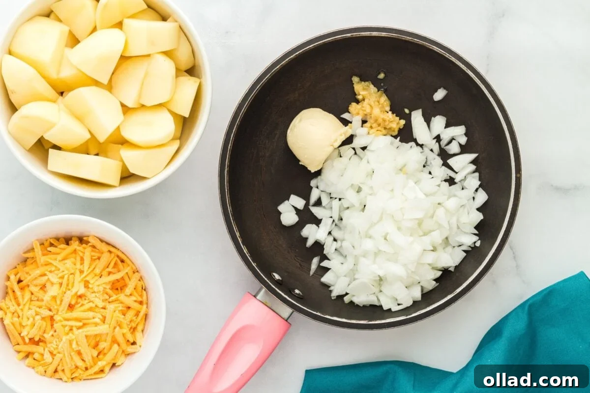A small skillet containing sautéing chopped onions, vegan butter, and minced garlic over a stovetop flame.