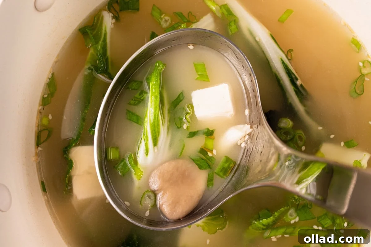 Savory Gluten-Free Miso Bowl 11 stainless steel ladle scooping gluten-free miso soup out of large pot
