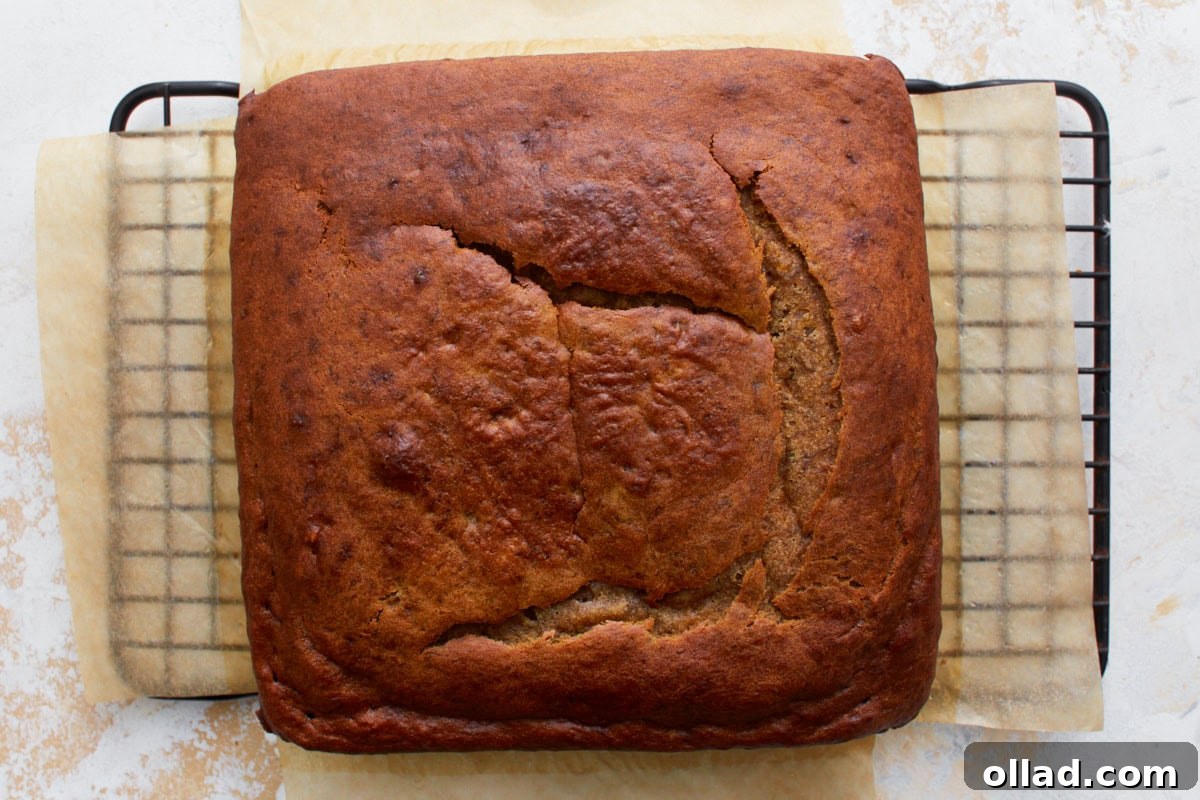 Irresistible Gluten-Free Banana Cake 8 Baked golden brown gluten-free banana cake cooling on a metal rack