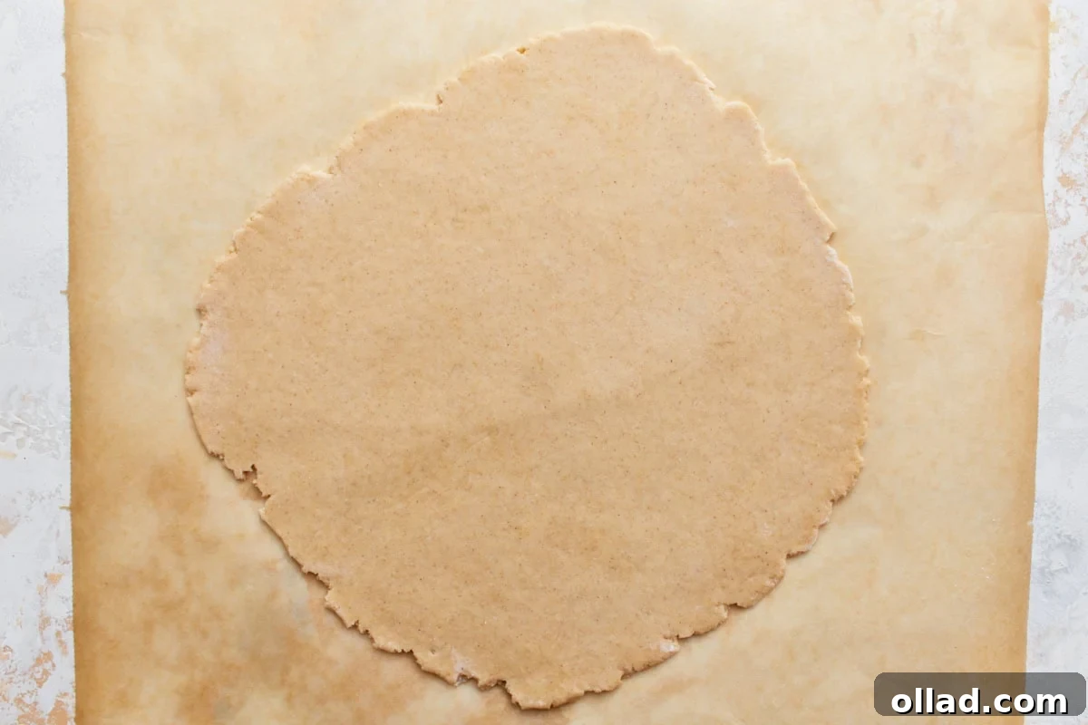 gluten-free cannoli dough rolled out onto parchment paper