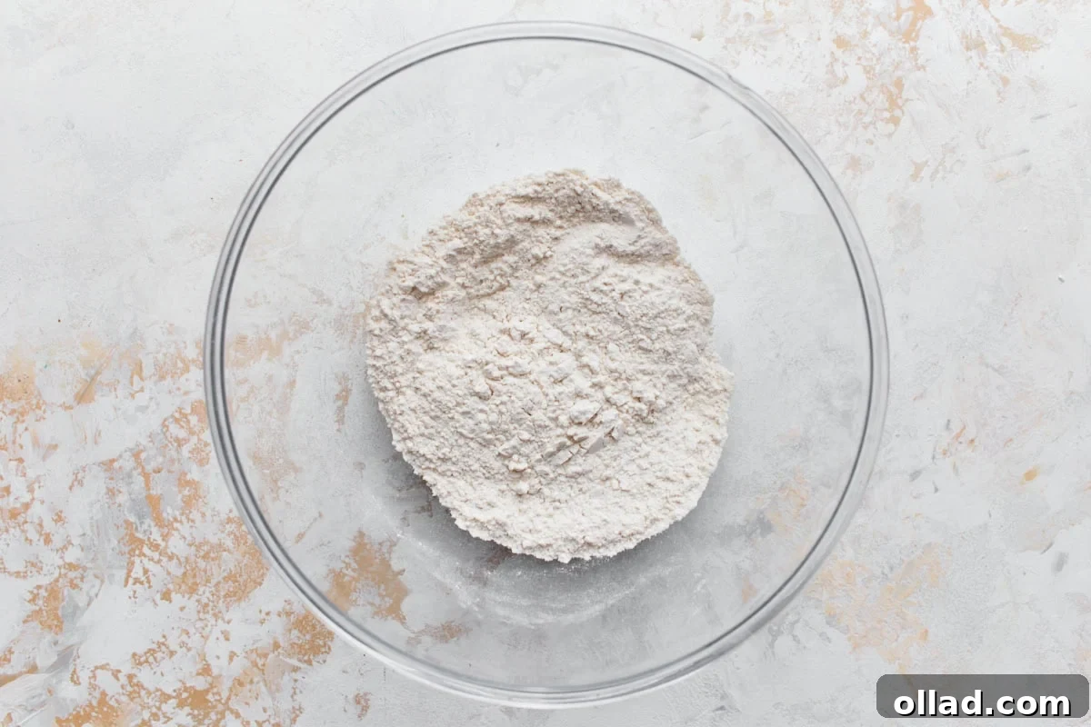 gluten-free flour mix in a glass bowl on a light surface