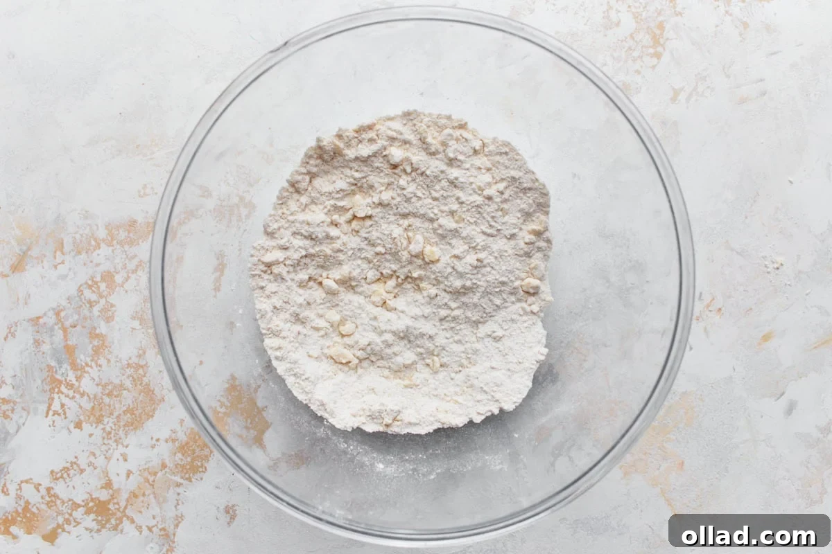 gluten-free flour mixture with butter chunks worked through in a glass bowl on a light surface