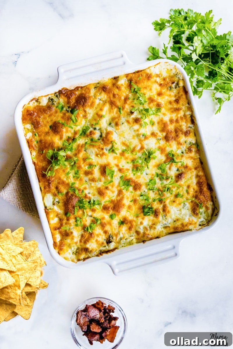Gluten-Free Game Day Victory Bites 4 spinach dip in a white baking dish with corn chips, chopped bacon, and parsley on the side