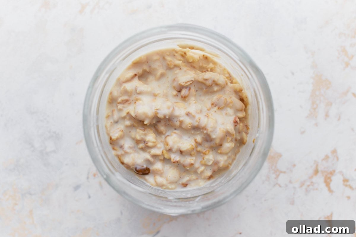 A jar of gluten-free overnight oats with a fully thickened and creamy texture after refrigeration.