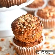 Paleo Carrot Cake Muffins Gluten Free Dairy Free Refined Sugar Free 5 two Paleo carrot cake muffins stacked on top of each other with more muffins in the background