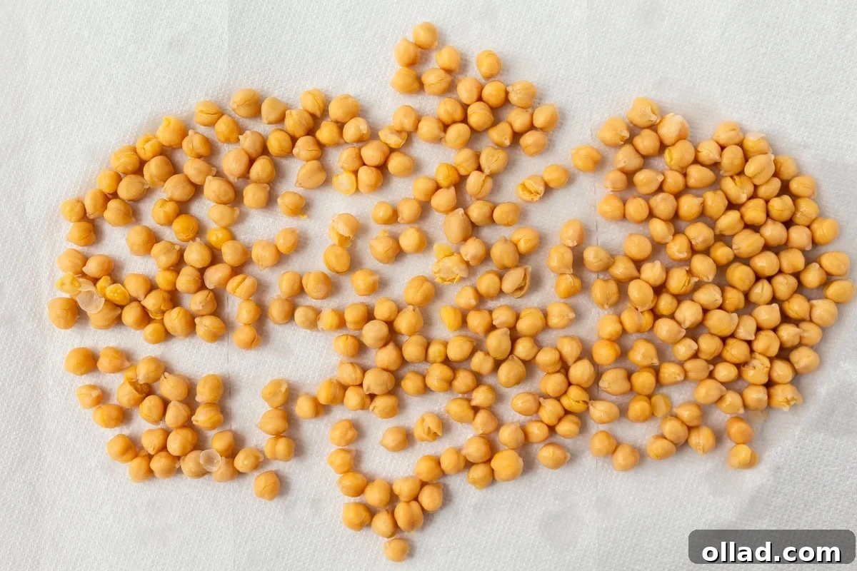 Mediterranean Quinoa Bowl 7 A spread of uncooked chickpeas drying on a white paper towel, perfectly prepped for roasting.