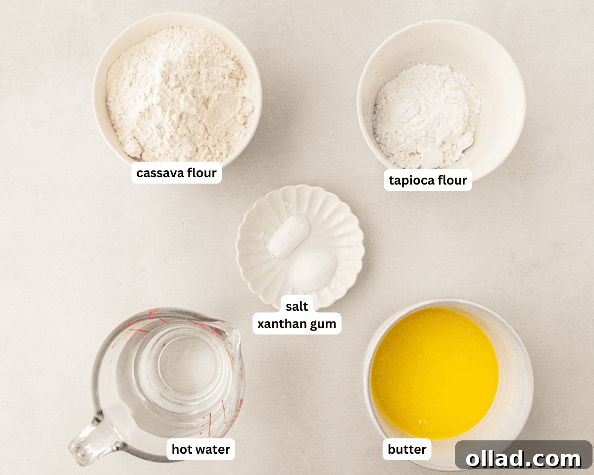 A vibrant collection of ingredients for cassava flour tortillas, including cassava flour, tapioca flour, salt, xanthan gum, melted butter, and hot water, neatly arranged for preparation.