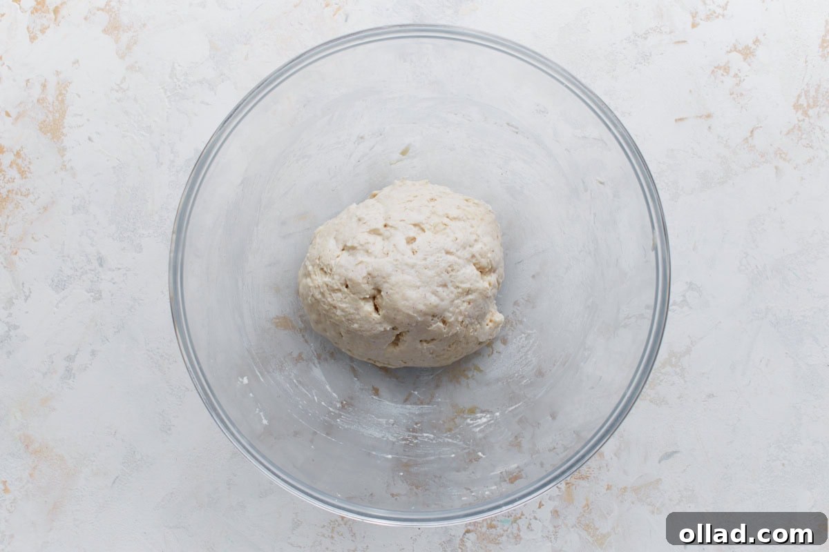 Irresistible Gluten-Free Pizza Poppers 5 A smooth ball of gluten-free dough resting in a glass bowl, ready to be rolled out.