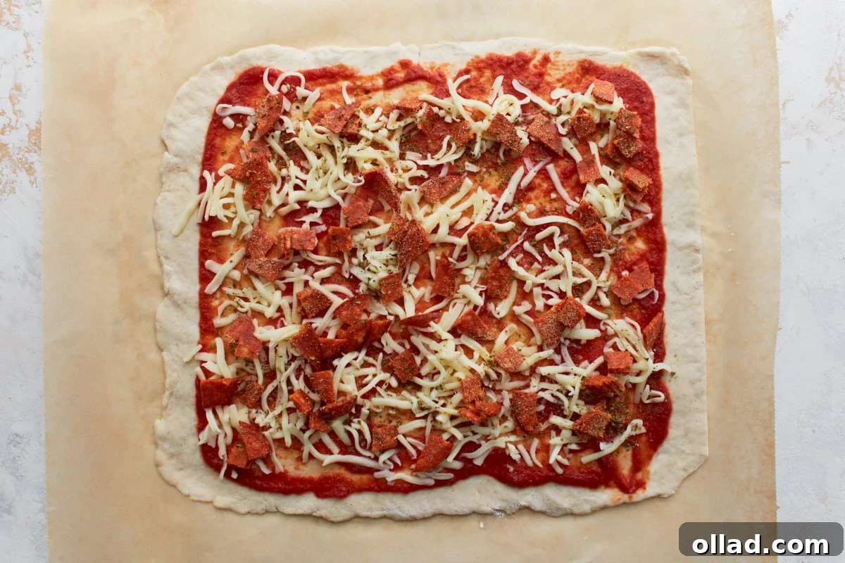 Irresistible Gluten-Free Pizza Poppers 8 Dough covered with shredded mozzarella, chopped pepperoni, and herbs over tomato sauce.