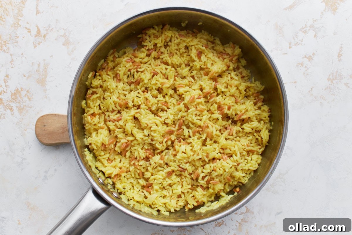Flavorful Gluten-Free Rice Pilaf 10 Fluffy, fully cooked gluten-free rice pilaf in a pan with golden pasta and tender rice mixed together.