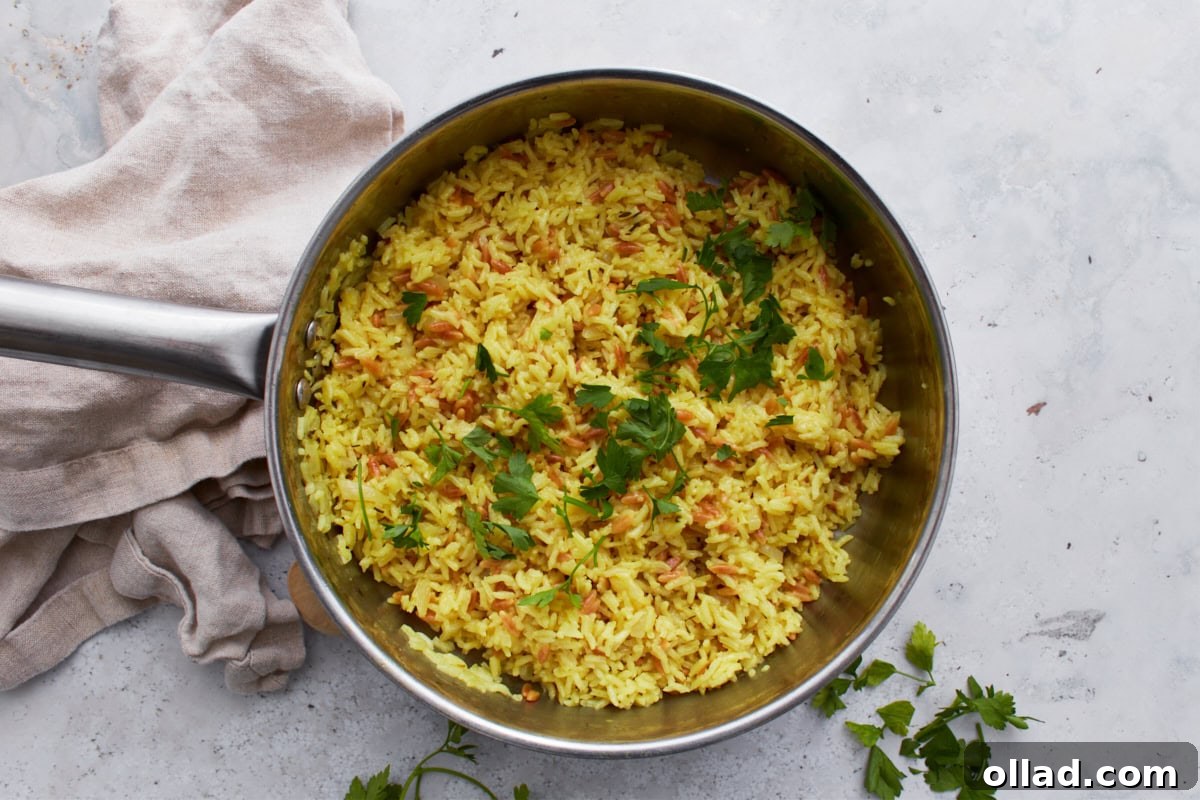Flavorful Gluten-Free Rice Pilaf 11 A pot of finished gluten-free rice pilaf garnished with fresh parsley, ready to serve.