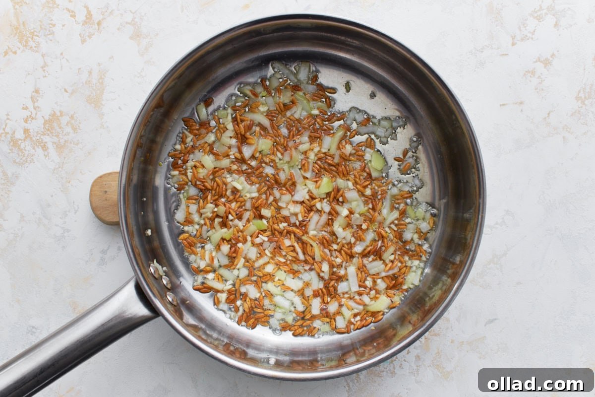 Flavorful Gluten-Free Rice Pilaf 7 Diced onions added to the toasted gluten-free orzo in a pan, beginning to soften and turn translucent.