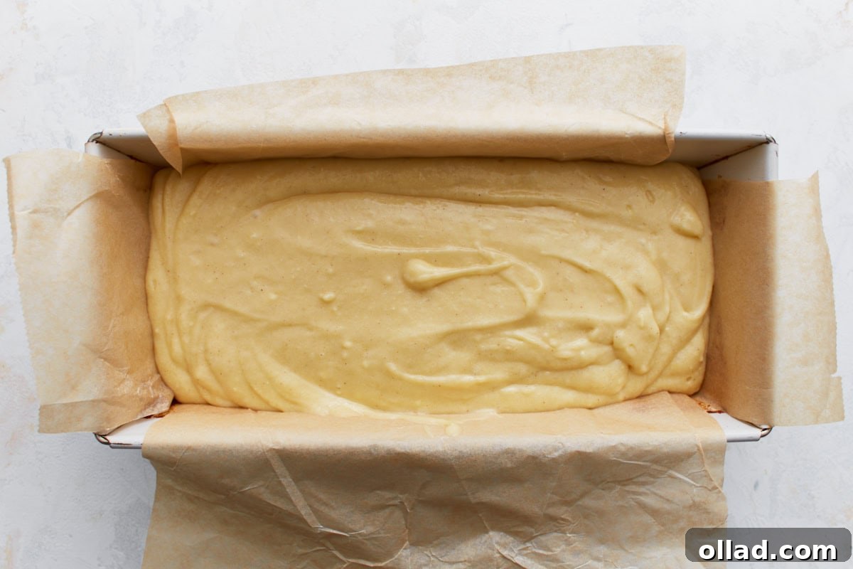 Gluten-Free Zesty Lemon Glaze Loaf 7 Lemon loaf batter poured into a parchment-lined loaf pan, ready for baking.