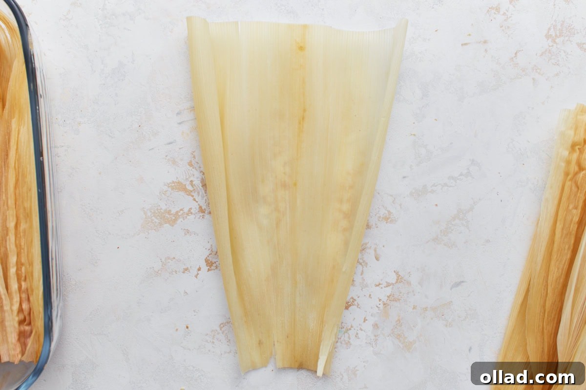 A single soaked corn husk laid flat and ready to fill.