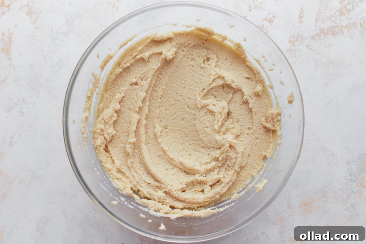 Smooth, spreadable gluten-free masa dough in a glass bowl, ready to use.