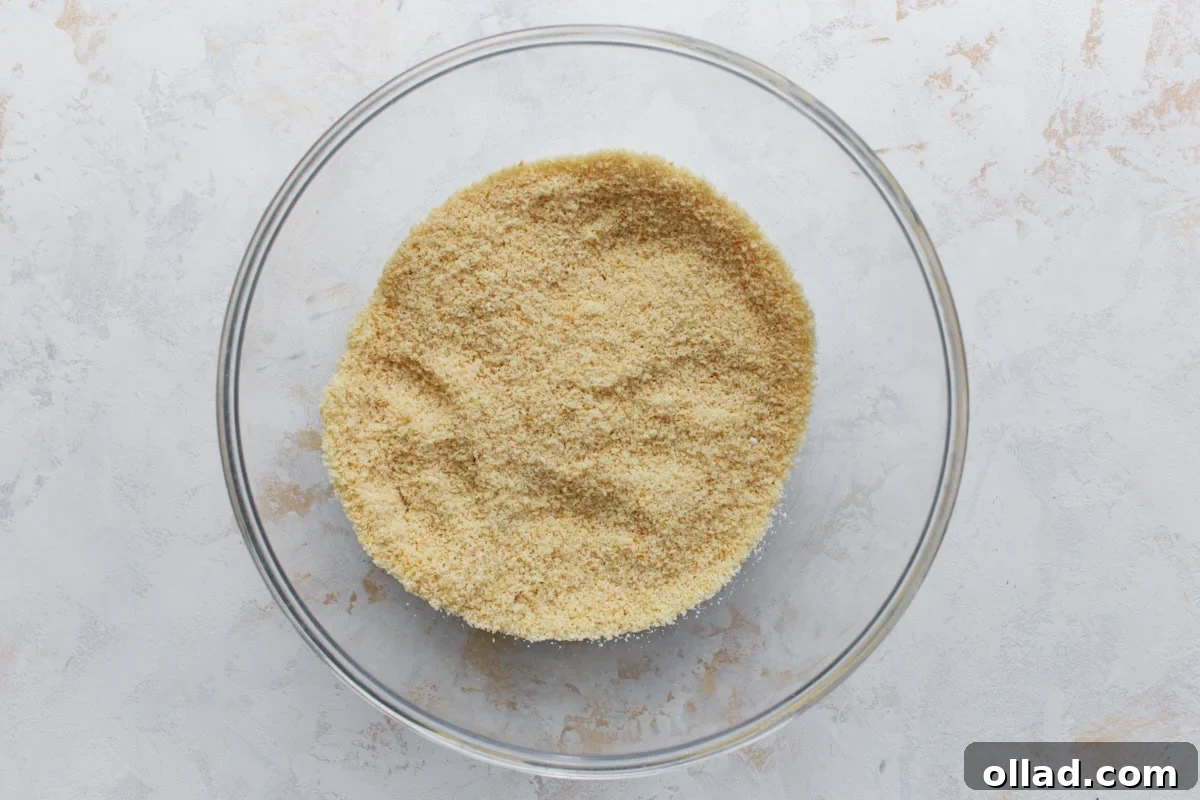 Dry ingredients for almond flour sugar cookies mixed together in a clear glass bowl.
