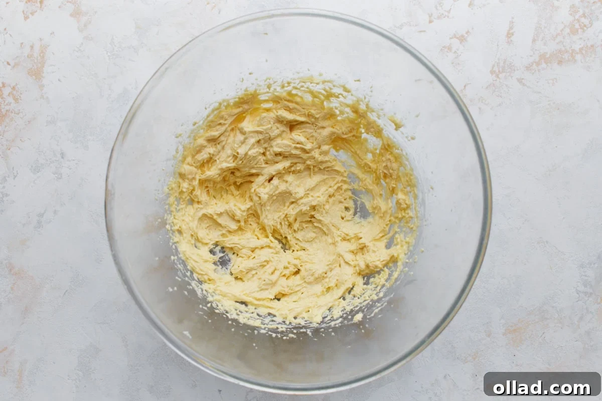 Butter, sugar, egg, and vanilla mixed together until smooth for almond flour sugar cookies.
