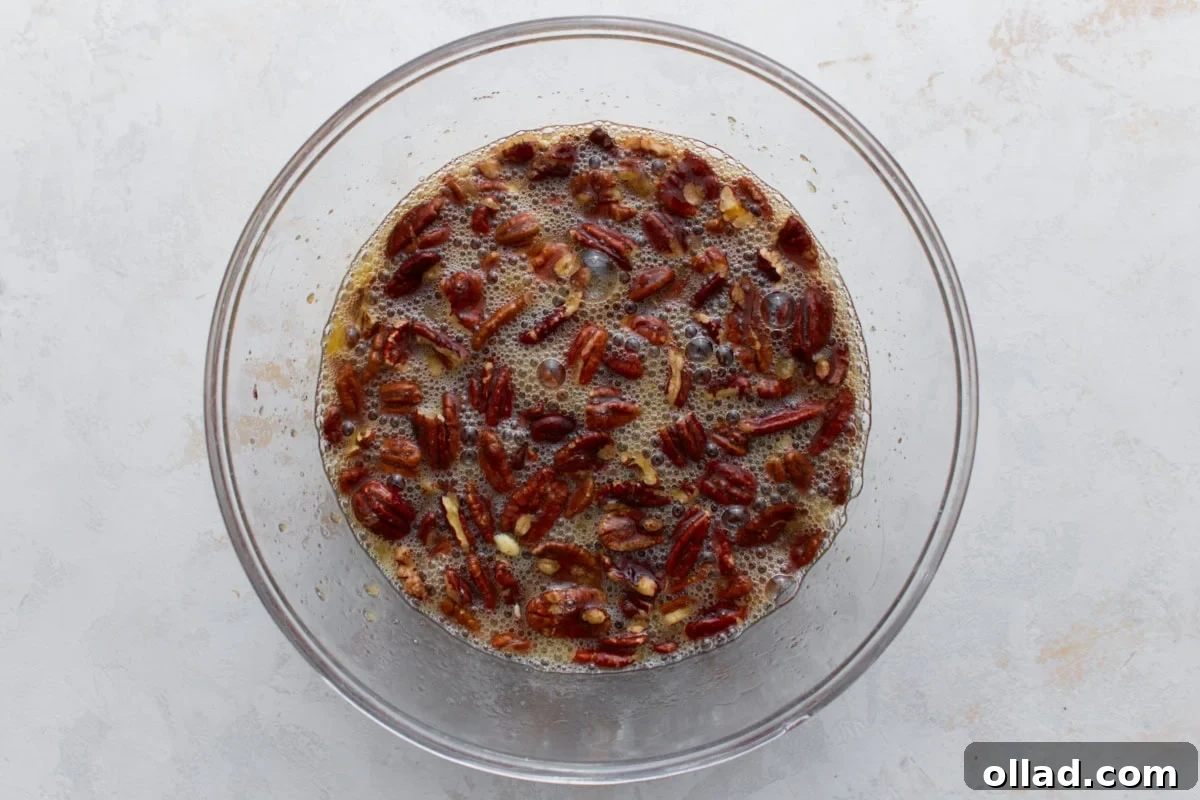 pecans being mixed into other ingredients for crustless pecan pie