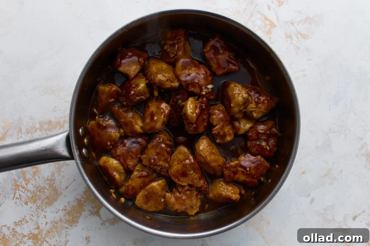 Crispy fried chicken tossed in sweet and spicy gluten-free General Tso’s sauce in a skillet