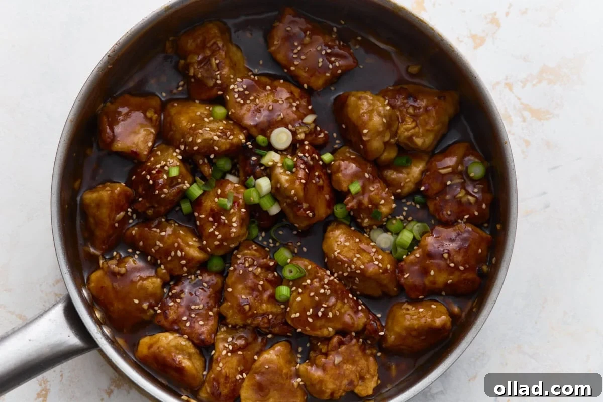 Overhead view of gluten-free General Tso’s chicken finished with sesame seeds and green onions