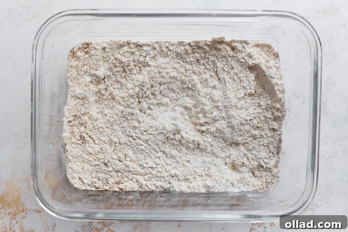 Cornstarch and gluten-free flour mixture for coating chicken in a glass baking dish