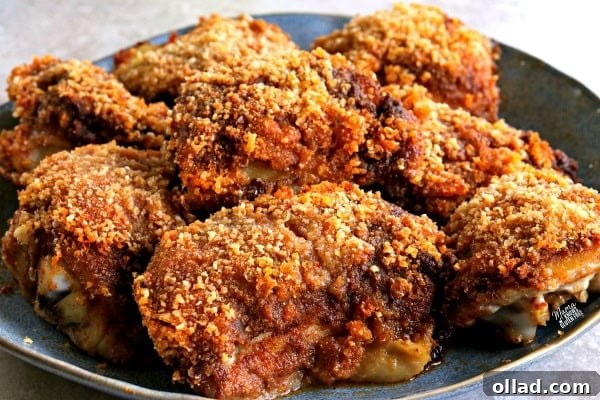 Close-up of crispy baked BBQ chicken thighs, golden and ready to eat