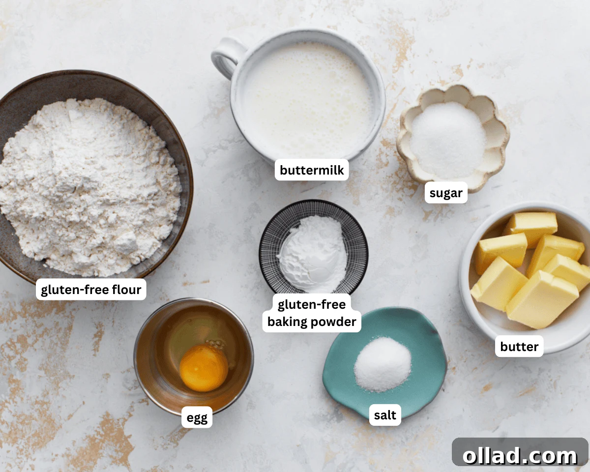 A collection of fresh ingredients for gluten-free buttermilk biscuits, including flour, butter, buttermilk, and eggs, neatly arranged on a countertop.