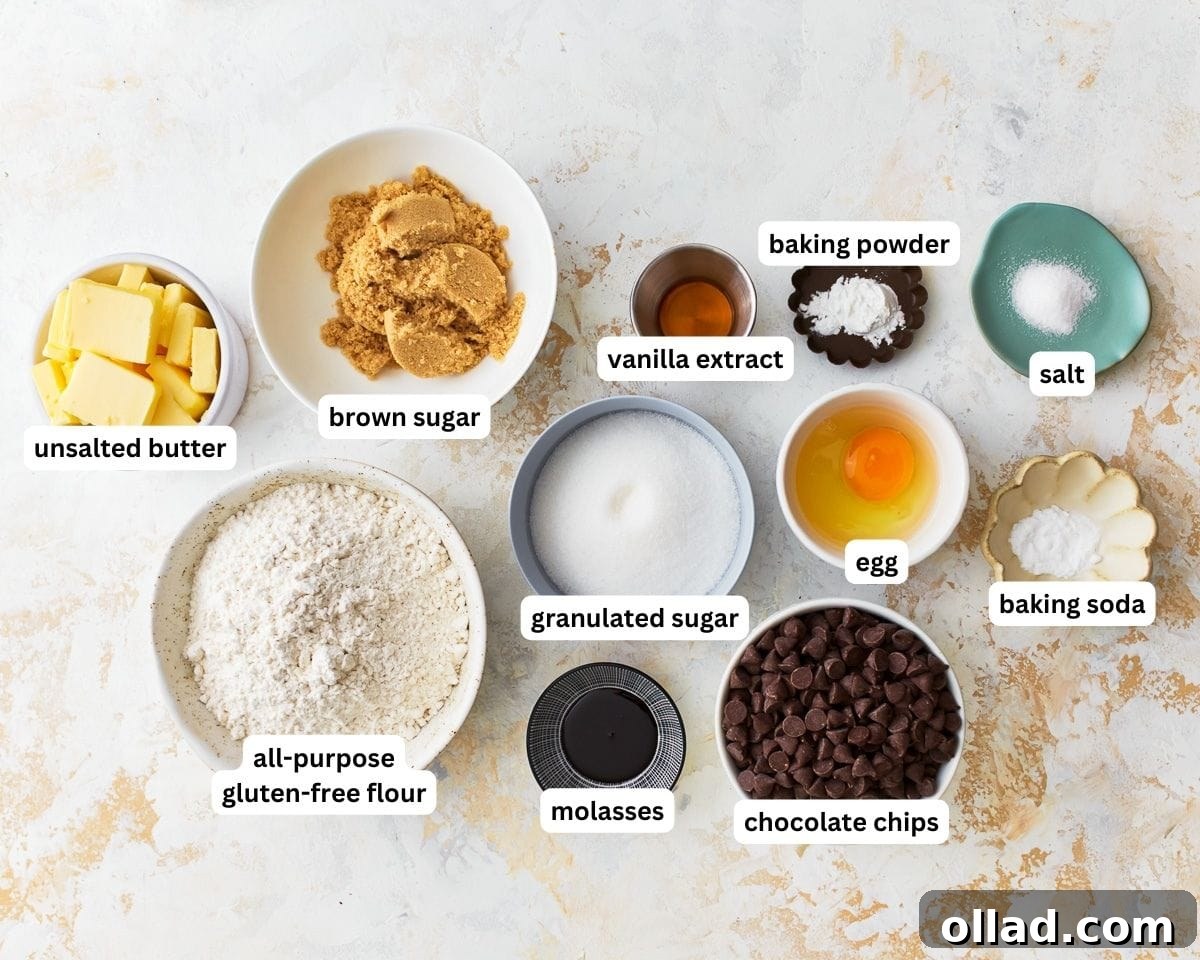 Various ingredients for gluten-free chocolate chip cookies laid out on a white surface, including flour, sugars, butter, and chocolate chips
