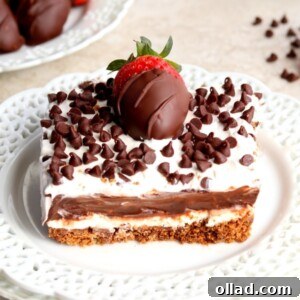 Guilt Free Chocolate Lasagna Bliss 8 Slice of chocolate lasagna with chocolate covered strawberries and chocolate chips in the background