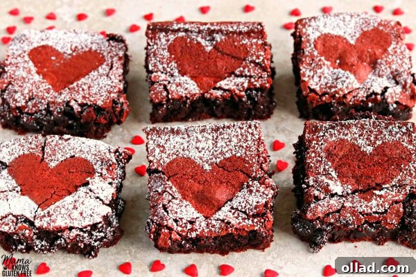 Fudgy Gluten-Free Dairy-Free Red Velvet Brownies 3 Six gluten-free red velvet brownies elegantly arranged with heart candies, perfect for a romantic gesture or sweet celebration.