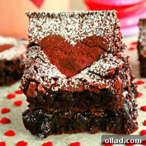 Two gluten-free red velvet brownies stacked with heart candies