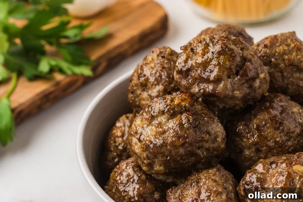 Delicious Gluten-Free Meatballs 12 Glossy, golden-brown gluten-free meatballs stacked in a white bowl, ready to serve.