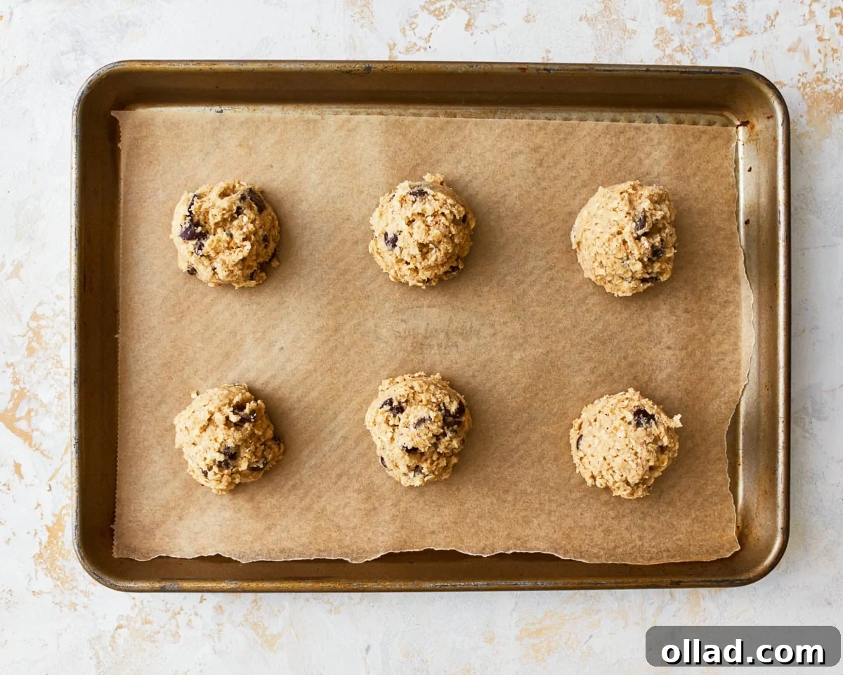 Wholesome Gluten-Free Oatmeal Cookies 11 6 gluten-free oatmeal cookie dough balls on a baking sheet.