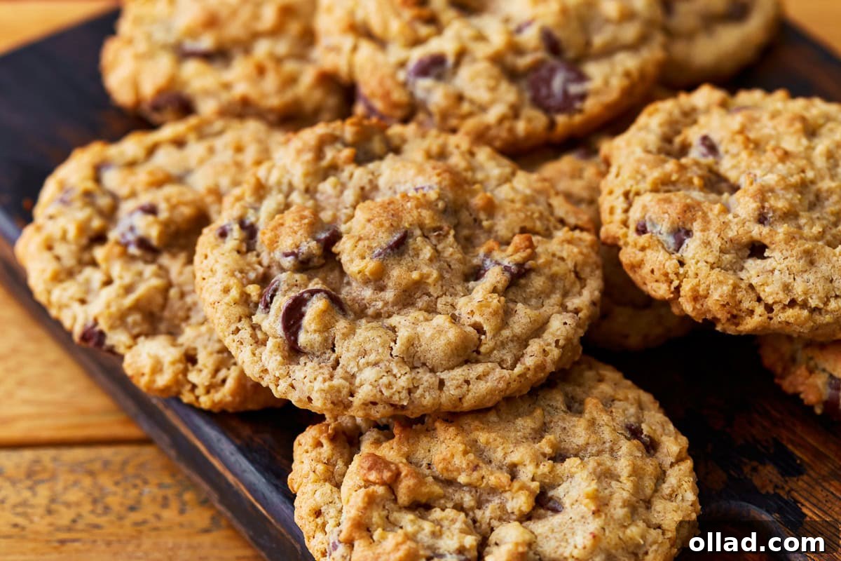 Wholesome Gluten-Free Oatmeal Cookies 4 gluten-free oatmeal cookies on a cutting board.