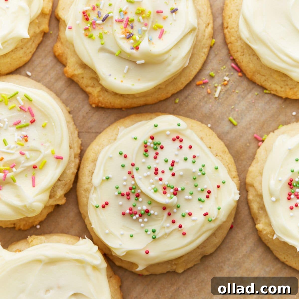 Close up overhead view of gluten-free sugar cookies topped with frosting and sprinkles.