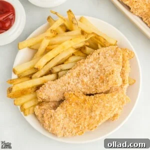 A vibrant platter of golden-brown gluten-free chicken tenders, perfectly crispy and ready for dipping. They are arranged appealingly, suggesting a satisfying crunch with every bite.
