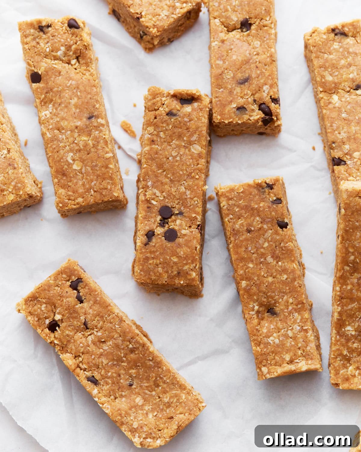 Simple & Delicious Homemade Gluten-Free Granola Bars 10 A batch of freshly prepared gluten-free granola bars displayed neatly on parchment paper, ready for serving or storage.