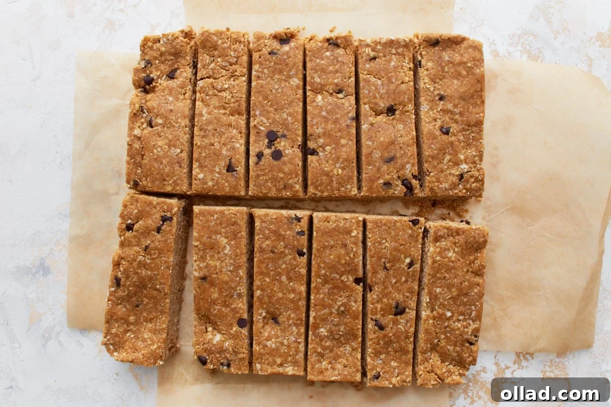 Simple & Delicious Homemade Gluten-Free Granola Bars 8 Freshly sliced gluten-free granola bars arranged in even rectangles on parchment paper, ready to be served.