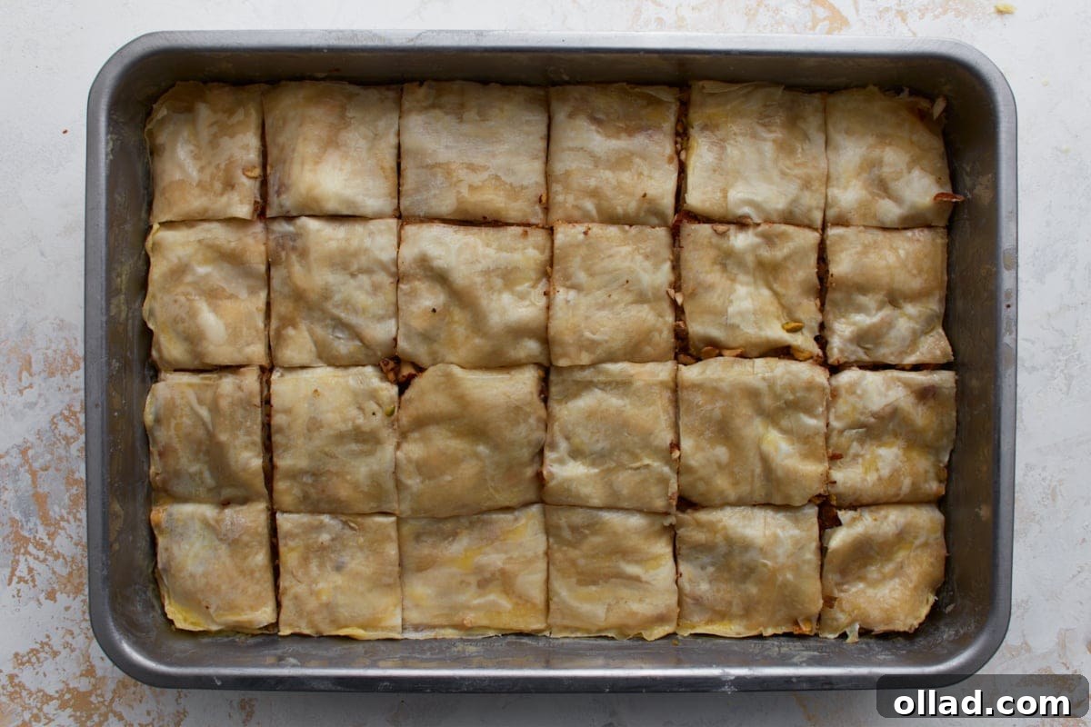 Gluten-free baklava cut into squares in a baking pan before baking.