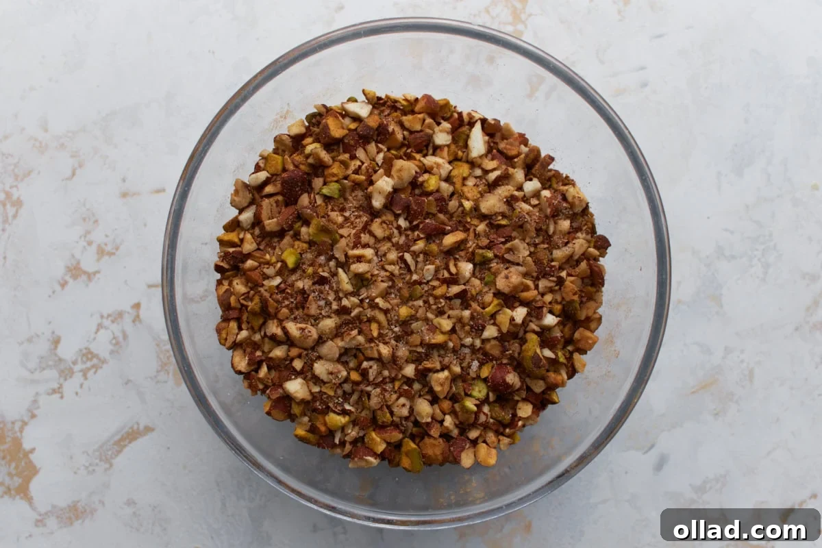 Chopped mixed nuts with cinnamon and sugar in a bowl for the baklava filling.