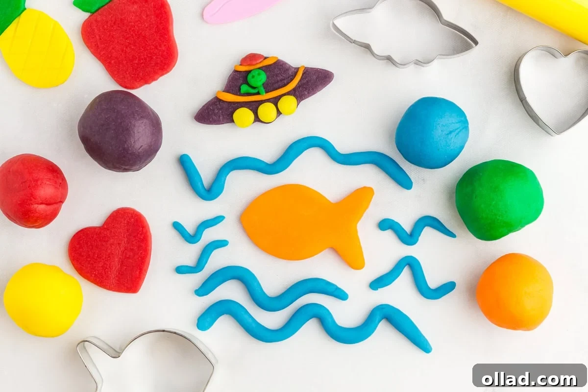 a pineapple, strawberry, heart, fish, waves, and a UFO scene made from colored play doh