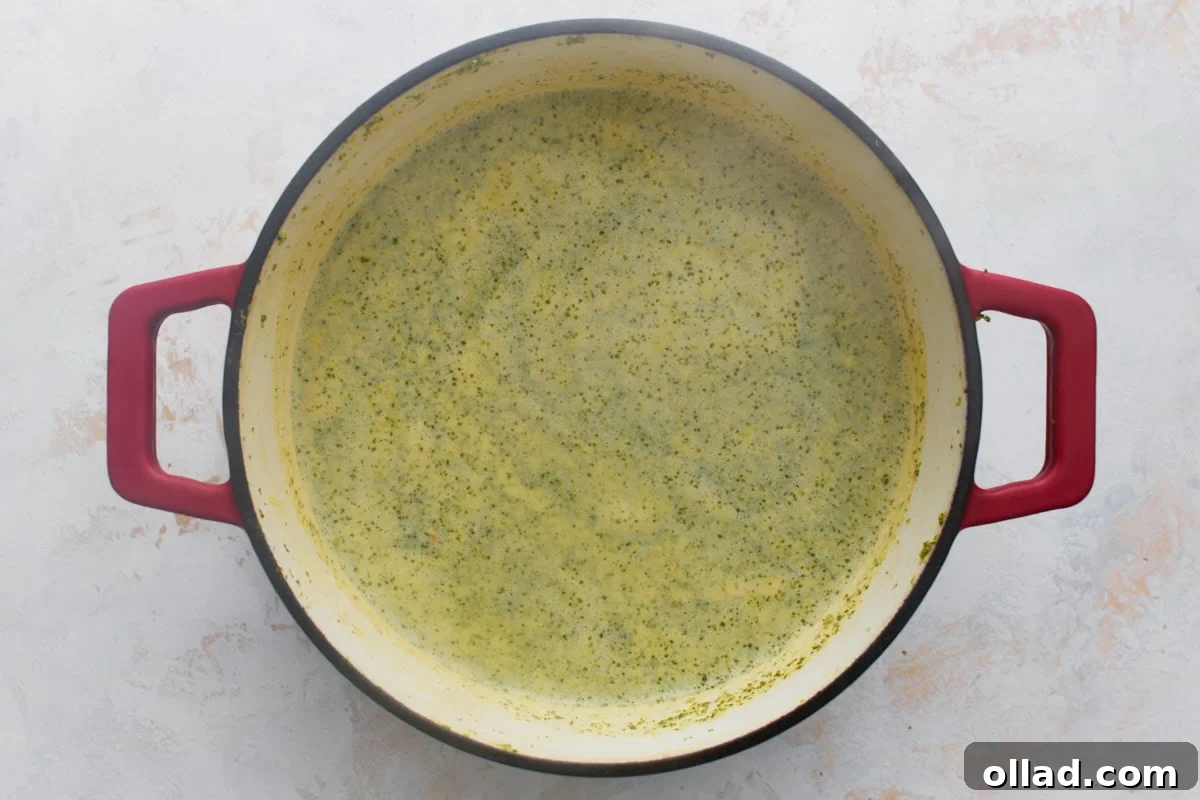 The soup turned a paler, speckled yellow-green after the half and half is stirred in, before it's thickened with the cornstarch slurry.