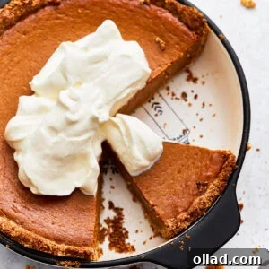 Overhead view of gluten-free pumpkin pie topped with whipped cream
