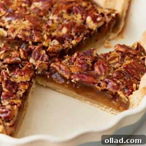 Side view of gluten-free pecan pie in a pie dish.