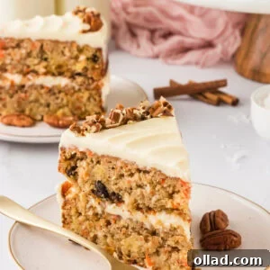 A close-up slice of gluten-free carrot cake with cream cheese frosting