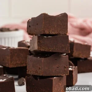 Stack of gluten-free dairy-free chocolate fudge squares topped with flaky sea salt