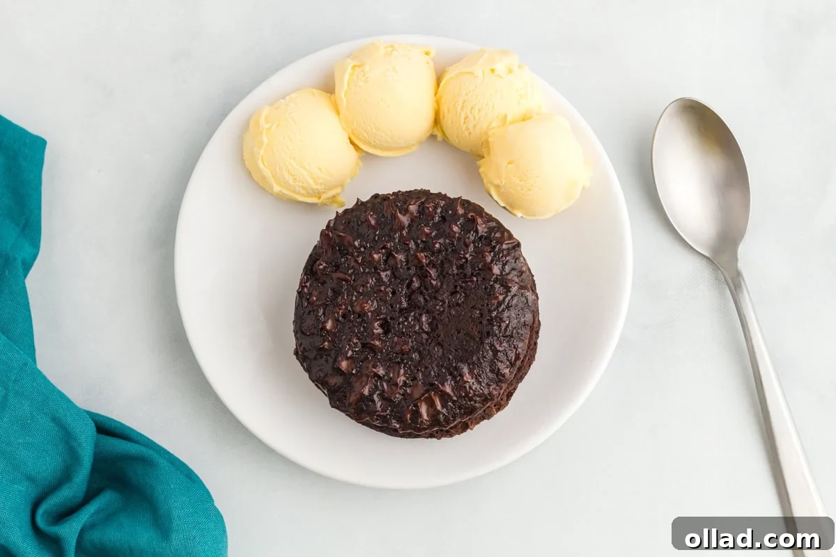 finished flourless mug cake served on a plate with vanilla ice cream